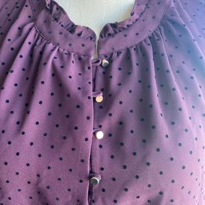 Purple and black polka dot shell with buttons